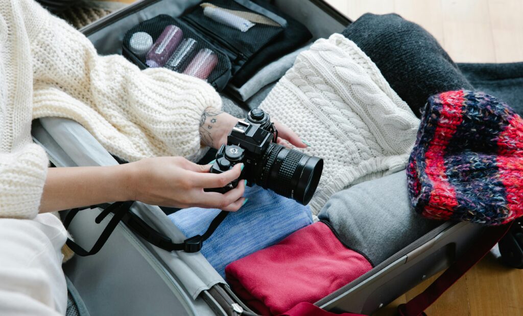Backpack with essential safari gear placed beside a safari jeep